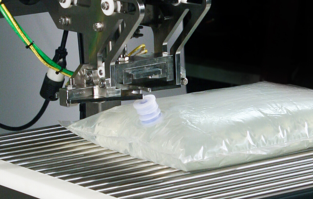 Aseptic bag with fitment on a bulk liquid filling line
