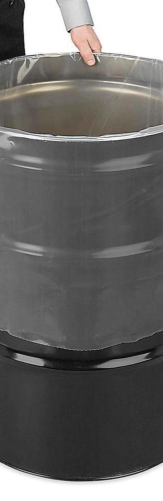 Polyethylene drum liners standing beside open drums